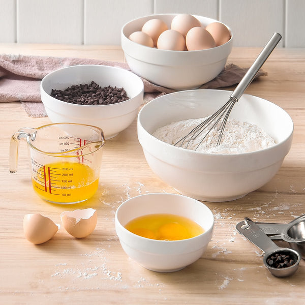 Baking ingredients and utensils on a wooden table