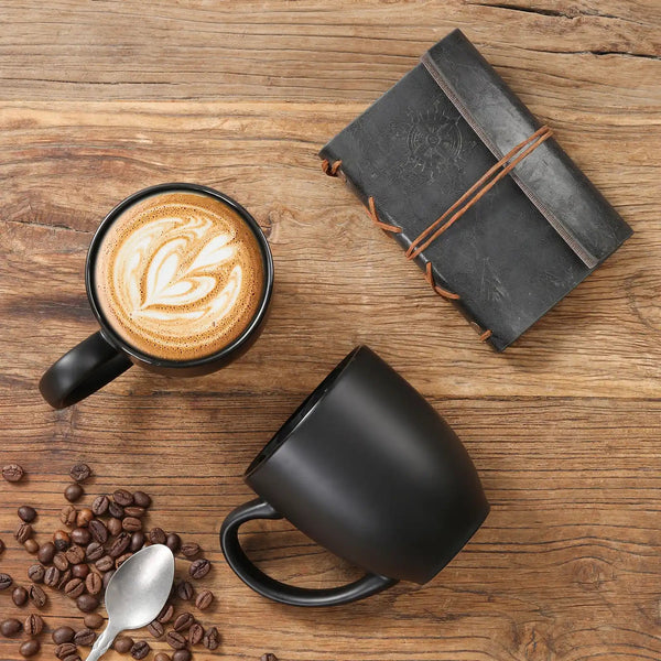 a cappuccino with latte art, coffee beans on a wooden surface.