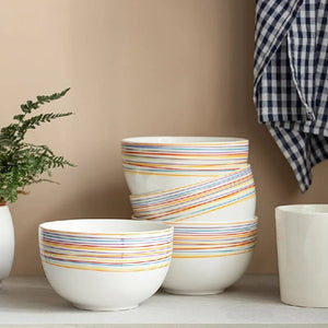 Set of ceramic pots with striped design on a neutral background