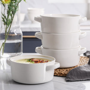 Stack of white ceramic bowls on a table with a blurred kitchen background