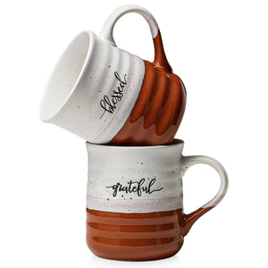 Two ceramic mugs with 'blessed' and 'grateful' text on a white background