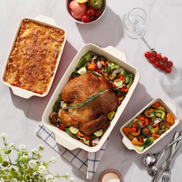 Dinner table with roasted turkey, vegetables on the three red baking dishes