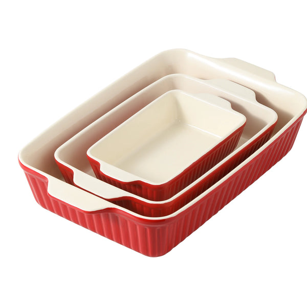 Set of three red and ceramic baking dishes on a white background