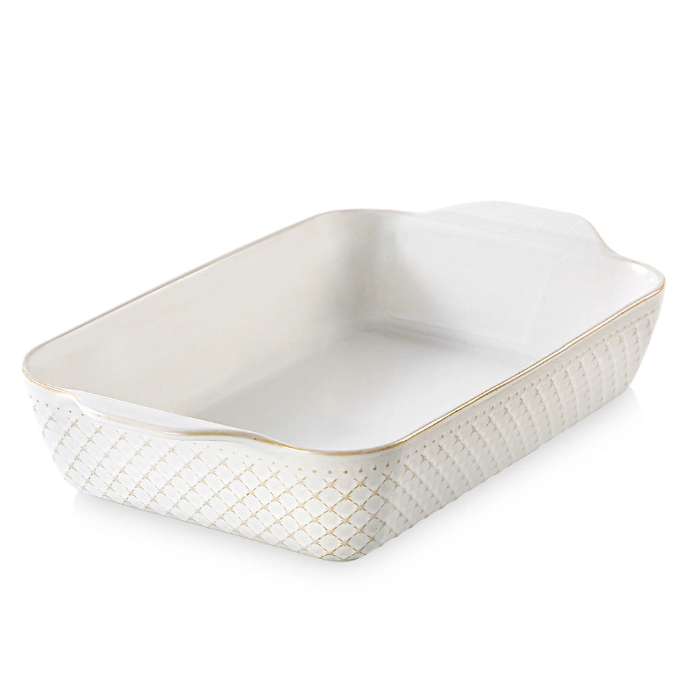 Rectangular stoneware baking dish with textured side and gold rim on a white background