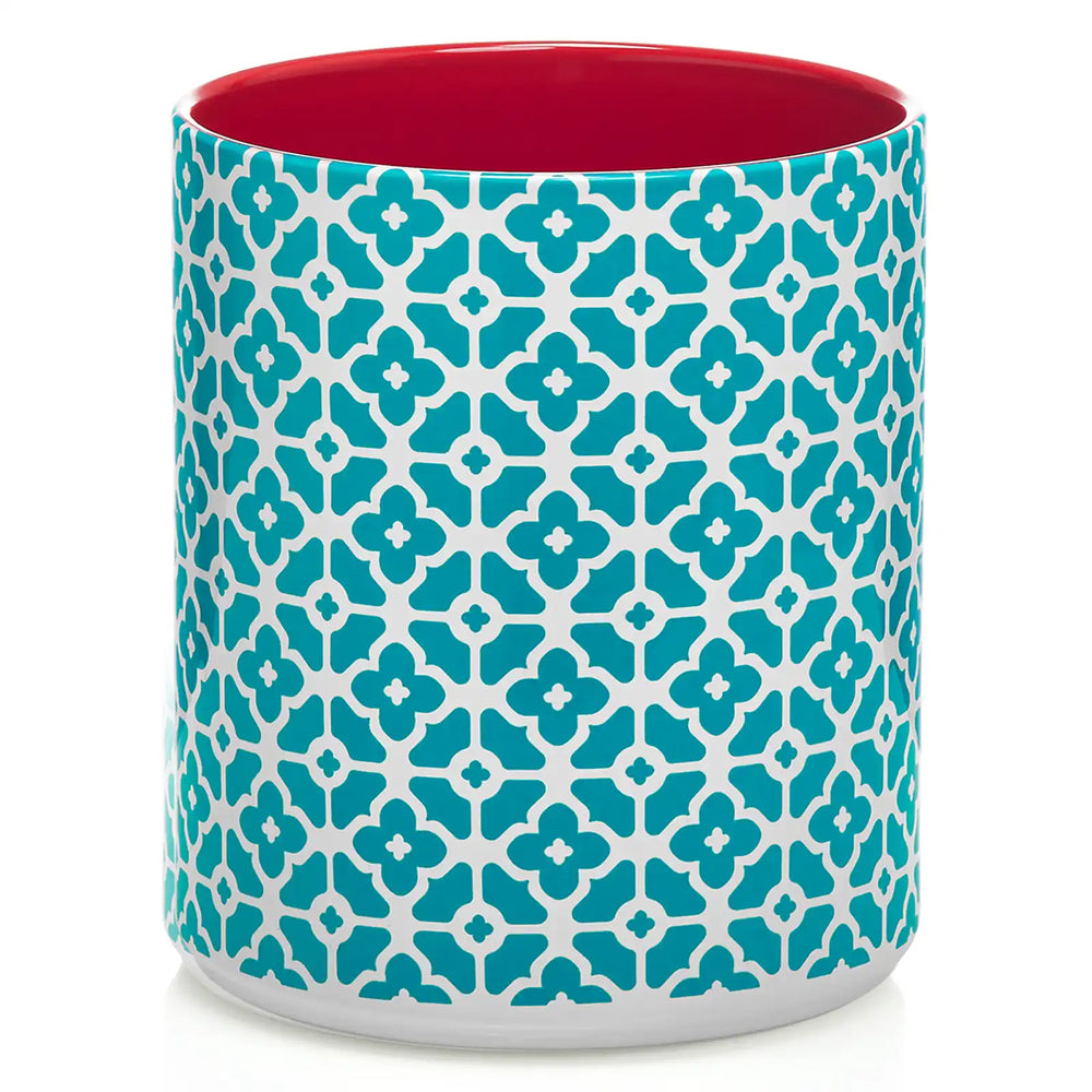 Cylindrical utensil holder with blue floral pattern and red interior on a white background