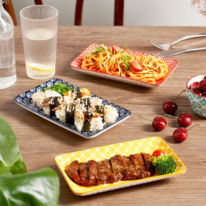 Diverse food items including sushi, spaghetti, and grilled meat on a wooden table.
