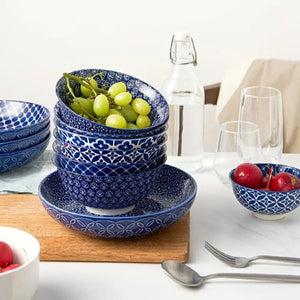 Set of blue ceramic bowls with white patterns on a dining table.