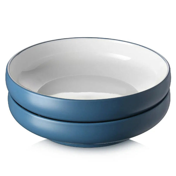 Two blue ceramic bowls stacked on a white background