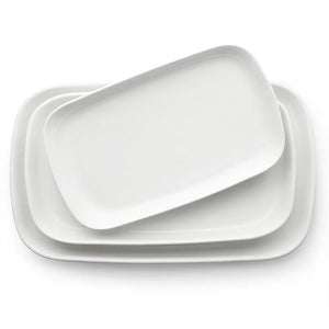 Set of white ceramic trays on a white background