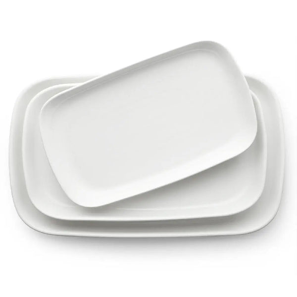 Set of white ceramic trays on a white background