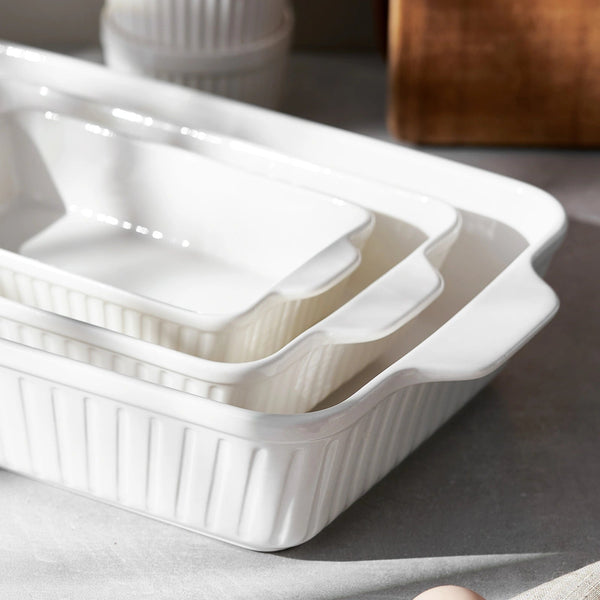 Set of white ceramic baking dishes on a gray surface
