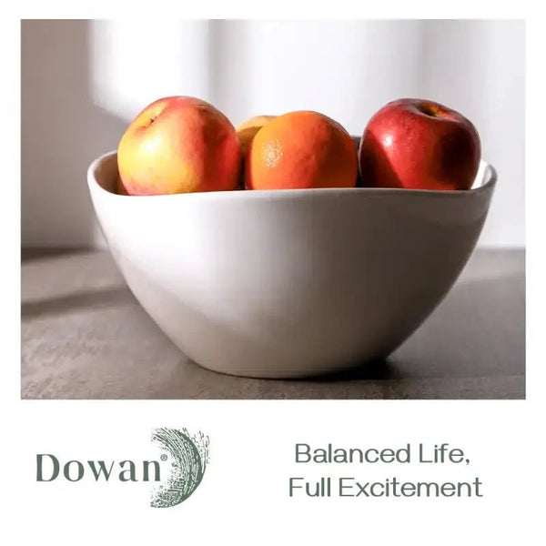 White bowl with apples on a neutral background, featuring the Dowan brand.